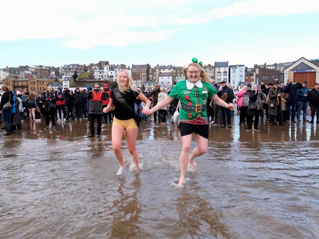 Participants having fun on South Bay at Scarborough's New Year Dip
