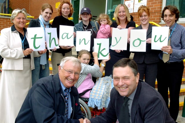 Children's Hospital Chief Exec Mike Sharaatt(right) along with patients and staff thank local bus driver Derek Russell (left), who has raised over £10,000,from a collection tin on his bus back in 2004
