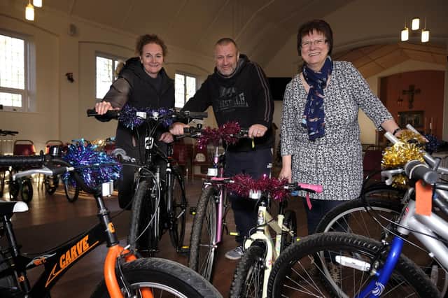 Rev Sam Taylor, Phil Sutcliff and Bernie Brown with the refurbished bikes at Eastfield's Holy Nativity Church