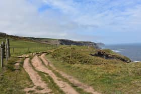 Dirt trek worn along the sea cliff of Robin Hood's Bay, on the Coast to Coast trail.