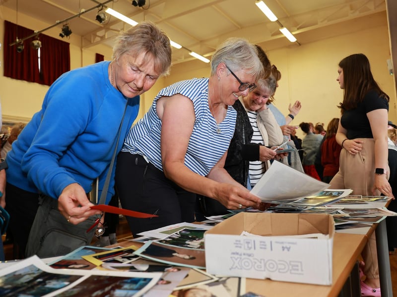 People enjoying looking at the archive pictures.