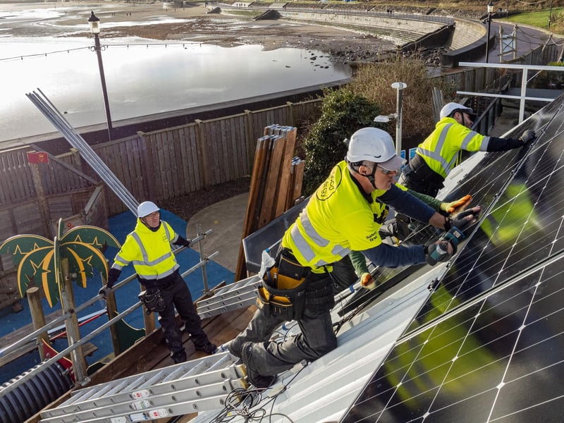 SMatt Andrews, a solar engineer and team leader, fixes a row of solar panels, completing a complex installation on the pyramid shaped roofs of SEA LIFE, Scarborough.   Photo by Toby Smith / Good Energy.