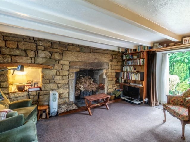 Open stonework to this feature wall with a lovely open fireplace in this sitting room.