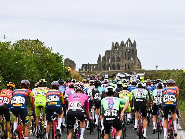 The Peloton passing Whitby Abbey.