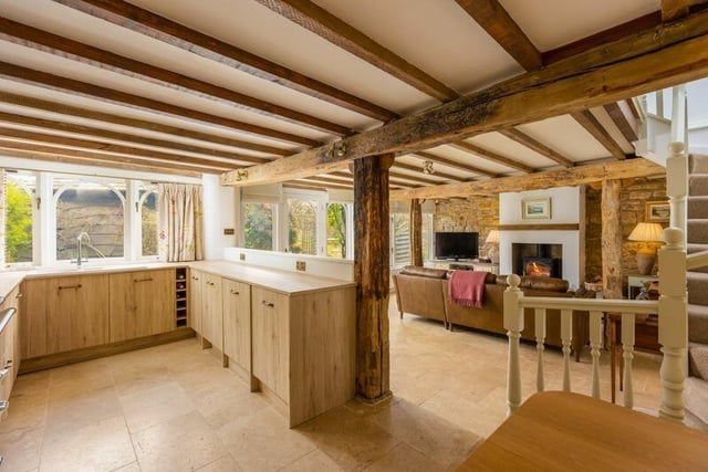 Kitchen through to sitting room with staircase up.