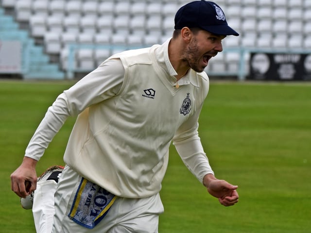 Matty Turnbull takes a fine catch and celebrates the first Grange wicket for Scarborough.