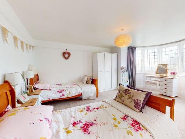 There is room for two double beds in this lovely bedroom with bay window.