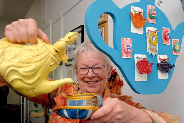 Gallery 6 owner Leslie Stones pours a cuppa at the exhibition Warming the Pot being held at the gallery in Victoria Road, Scarborough