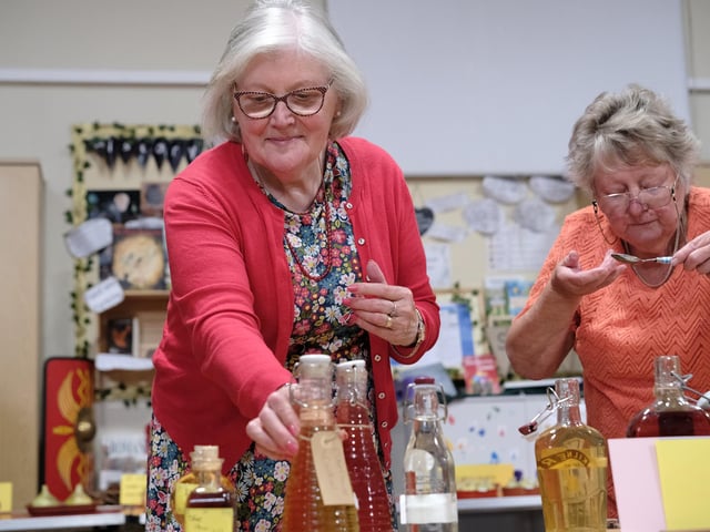 Rita Worthy checks the bottles.