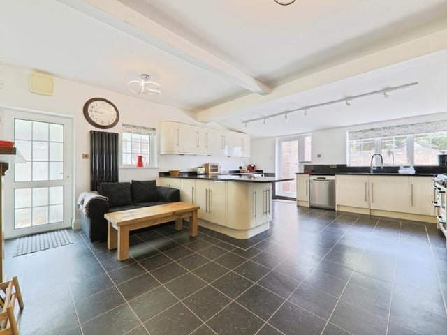 The bright and modern kitchen, with doors to outside.
