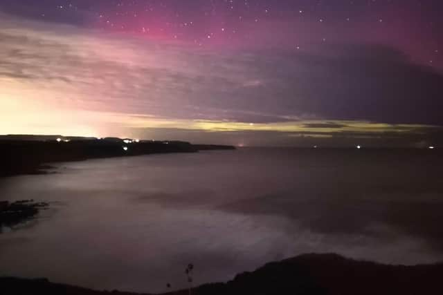 Stunning capture of purple and green Northern Lights off Scarborough's Scalby clifftops.