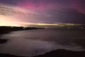 Stunning capture of purple and green Northern Lights off Scarborough's Scalby clifftops.