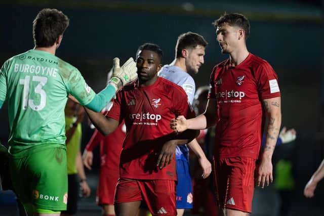 Boro and Alfreton players shake hands after the final whistle. Photo by Wandering Photography