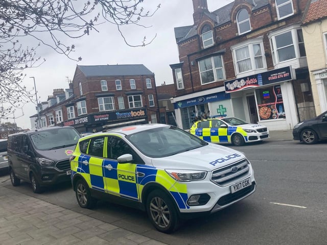 Many police vehicles are pictured at the scene.