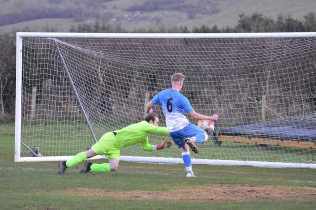 Tom Stockdale scores Heslerton's all important second goal in the top of Beckett League Division Two clash, which saw them beat Danby 3-0.