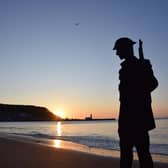 A cardboard depiction of a soldier at sunrise on Scarborough’s South Bay. Photo: The Animated Objects Theatre Company