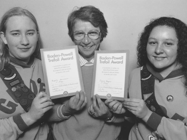 Guides Angela Dennison, left, and Maria Hayes, received their Baden Powell awards from Guide Guider Janice Phillips in March, 1996. 