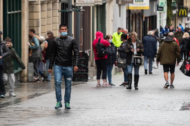 Some still feel the need to cover their faces when they leave their homes. Photo: Kelvin Stuttard