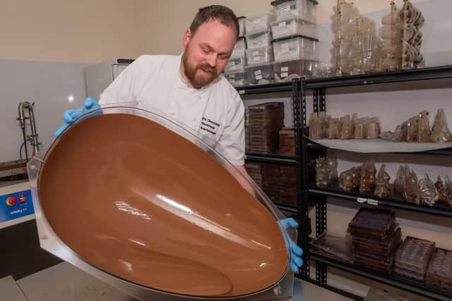 Alex Grant of Crofts Chocolates in Scarborough hard at work perfecting a giant Easter egg.