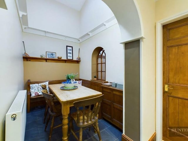 An arched window and wood panelling add character to this room.