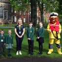 Helen Massey (centre) with pupils of Silcoates School, volunteer student Amir in RNLI inshore lifeboat crew kit and Stormy Stan - Image Courtesy of Silcoates School