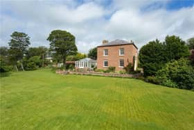 The property is privately situated within the village, and has established lawned gardens.