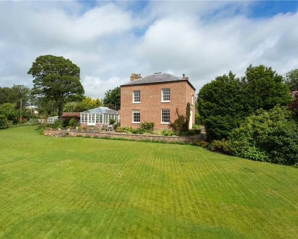 The property is privately situated within the village, and has established lawned gardens.