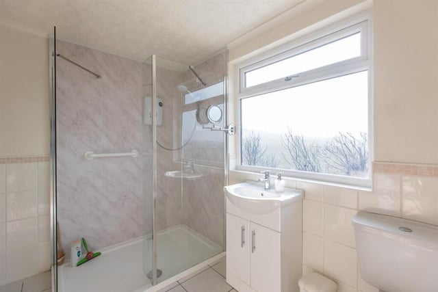 A stylish shower room with walk-in shower unit.