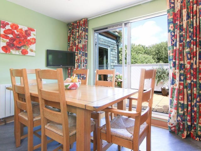The cozy dining area is connected to the kitchen and looks out onto the balcony area, with the glass doors allowing plenty of light to filter in.
