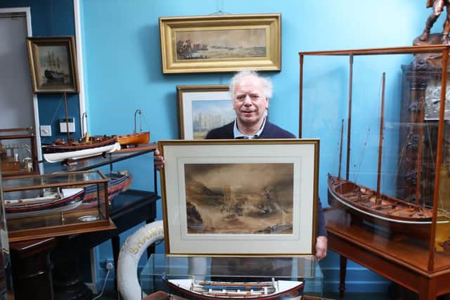 Charles Wallrock of Wick Antiques with the painting and other RNLI items from his new book