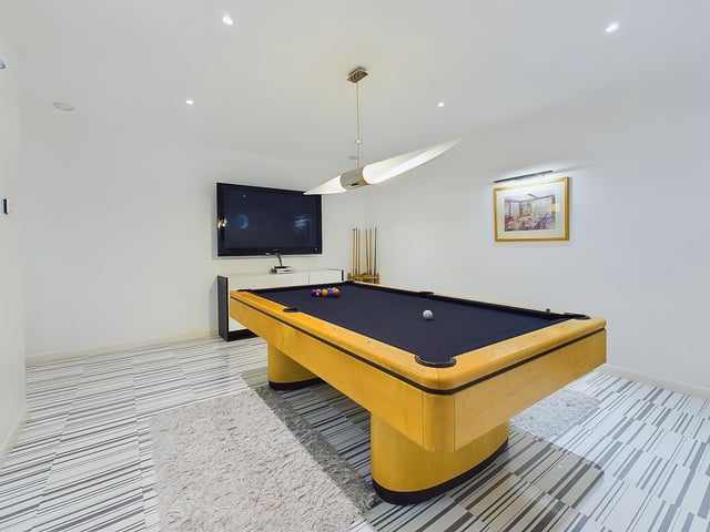 A billiards room adds to the entertainment facilities.