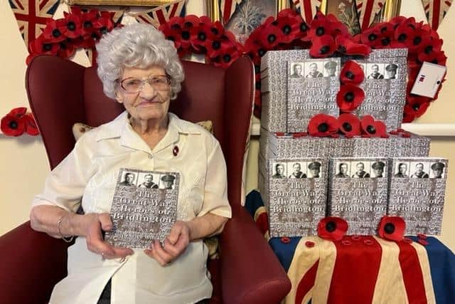 Alice Brown, resident of Sandylane Care Home in Bridlington, showcasing the new edition of "The Great War Heroes of Bridlington".