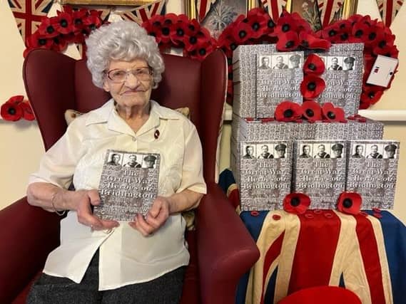 Alice Brown, resident of Sandylane Care Home in Bridlington, showcasing the new edition of "The Great War Heroes of Bridlington".