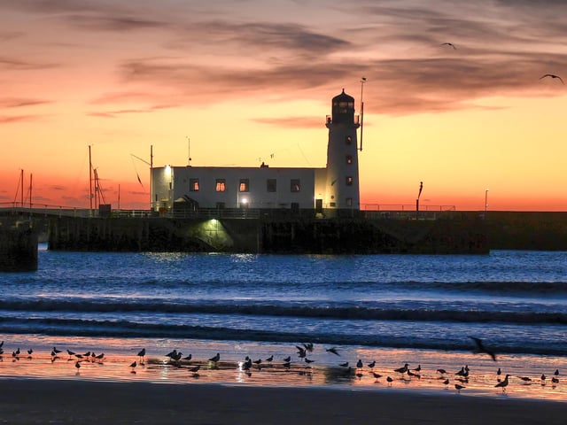 Serene sunrise at the lighthouse.