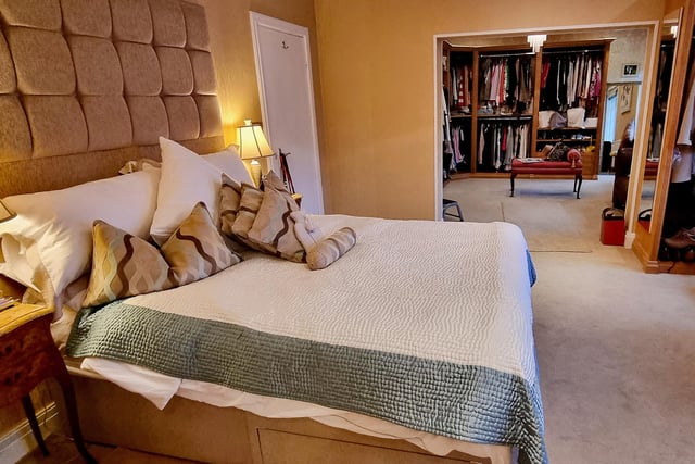 A deluxe bedroom with open plan dressing room and en suite facilities.