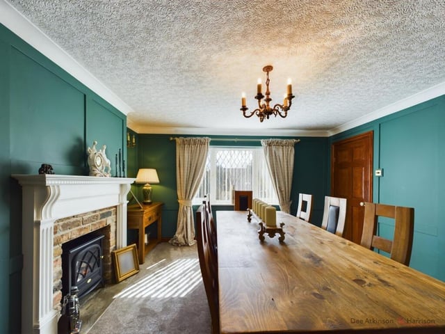 A large dining room with fireplace and stove.