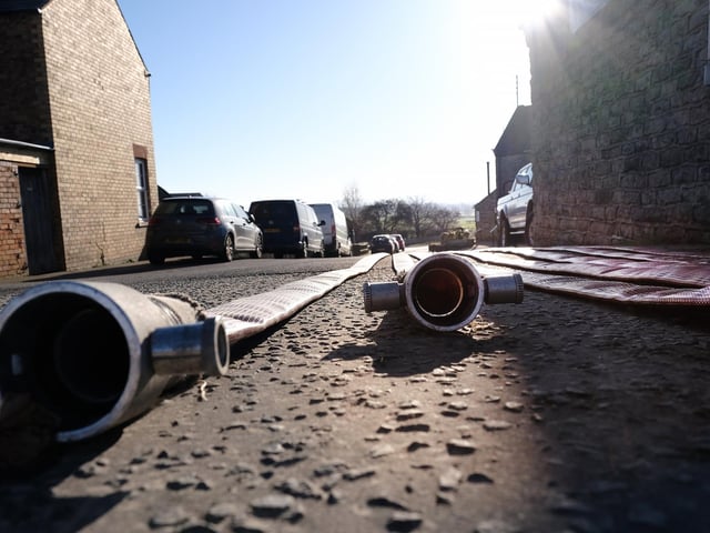 Hose reels lie at the entrance to Betton Farm