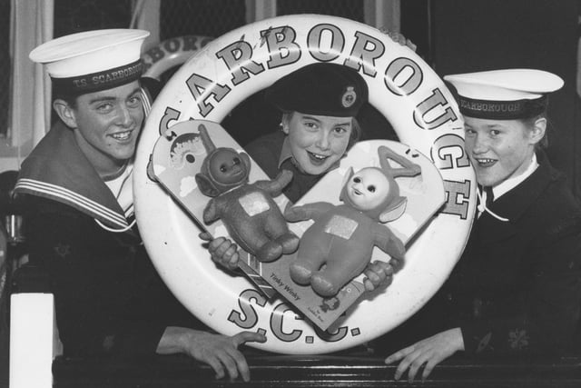 Sea Cadet Louise Smith is pictured with two of the precious Teletubby dolls the Scarborough unit were raffling for Christmas to raise funds in December, 1997. Louise is pictured with Able Cadet Mathew Davies, left, and Cadet Andrea Sheader. 