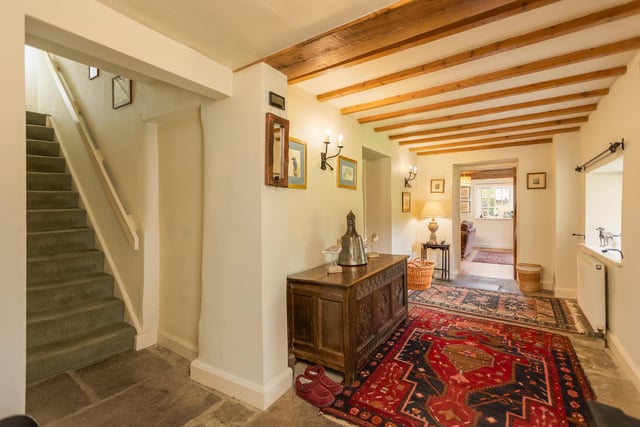 The beamed hallway leads in to the open plan kitchen and homely lounge.