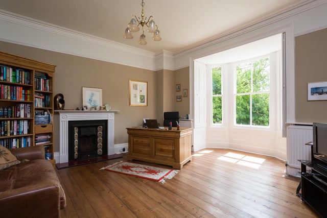 The sitting room has stunning features in its bay window and fireplace.