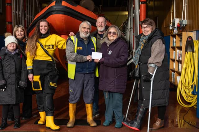 Lifeboat Operations Manager, Sean Baxter, accepting the donation from the family of Alan Barwick.  picture: RNLI/James Stoker
