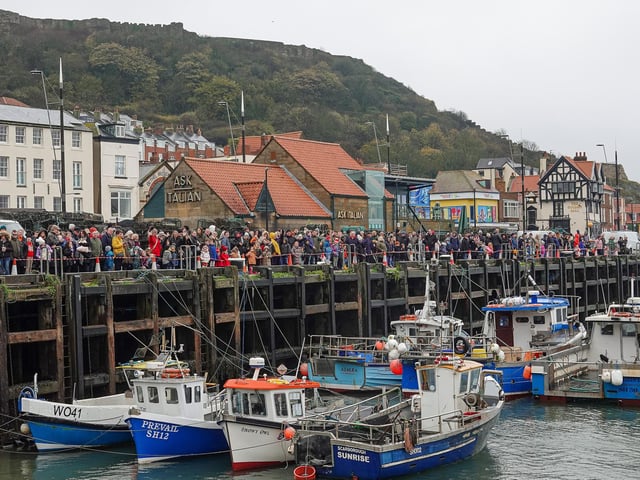 The crowd lined up along the harbour.