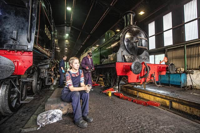 Engineers prepare various engines for the days work in the main railway workshop at Grosmont/