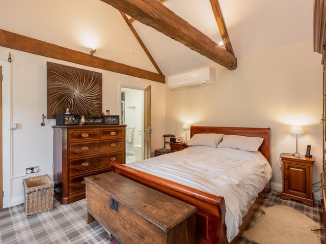 A double bedroom with vaulted ceiling.