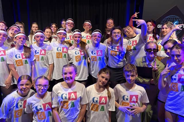 The full cast of Whitby School's We Will Rock You backstage.