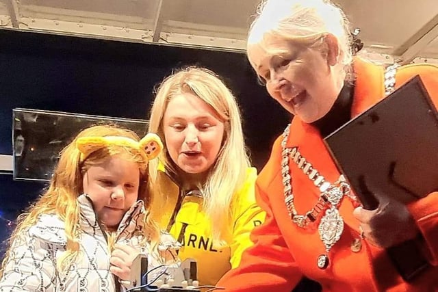 Alya Stamp, 6, of East Whitby Academy, turns on Whitby's Christmas lights with Leah Hunter of Whitby RNLI and the Town Mayor, Cllr Linda Wild.
picture: Alan Wastell.