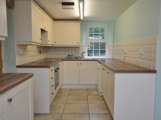 A kitchen with diner has fitted shaker-style cabinets.