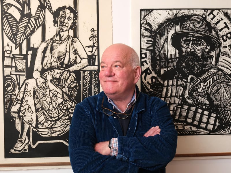 Artist Ian Burke with some of his work exhibited.