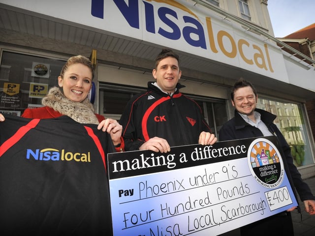 Nisa local on North Marine Road present a cheque for £400 to the Phoenix U9's football team. From left, Rosie White of Nisa, Chris Kendall of Phoenix U9s and Daniel Wilson of Nisa. Picture by Neil Silk