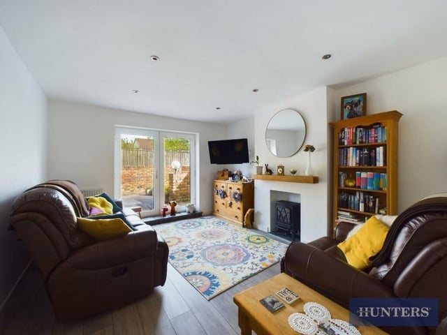 The lounge ha a feature fireplace and French doors to the garden.